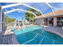 Inviting kidney-shaped pool with a screened enclosure at 256 Coblentz St, Port Charlotte, FL 33954