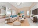 Spacious living room with beige sofa, a coffee table, and a large flat-screen TV at 523 Foxwood Blvd, Englewood, FL 34223