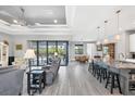 Open living space with gray tile floors, recessed lighting, and sliding doors to pool at 10721 Ayear Rd, Port Charlotte, FL 33981