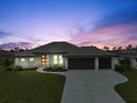 Newly constructed home with three-car garage; sunset view at 261 Broadmoor Ln, Rotonda West, FL 33947