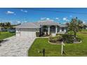 One-story house with a paved driveway and manicured lawn at 15418 Alcove Cir, Port Charlotte, FL 33981