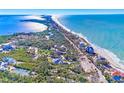 Bird's eye view of beachfront home with lush landscaping and ocean access at 7161 Manasota Key Rd, Englewood, FL 34223