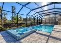 Relaxing pool and spa area with screened enclosure at 7161 Manasota Key Rd, Englewood, FL 34223
