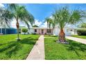 Mid-century modern home with walkway and lush lawn at 544 Lindley Ter, Port Charlotte, FL 33952