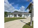 Single-story house with a landscaped yard and driveway at 881 Bayshore Dr, Englewood, FL 34223