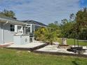 Outdoor kitchen and fire pit area at 881 Bayshore Dr, Englewood, FL 34223