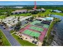 Community view showing tennis courts, pool, and building at 175 Kings Hwy # 233, Punta Gorda, FL 33983