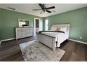 Bright bedroom with wood floors, ceiling fan and en-suite bathroom at 35 Mark Twain Ln, Rotonda West, FL 33947