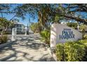 Welcoming entrance to 11000 Placida Harbour with lush landscaping and elegant signage at 11000 Placida Rd # 2303, Placida, FL 33946