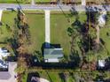 Aerial view showing home's location on a large lot with driveway at 1115 Larchmont Dr, Englewood, FL 34223