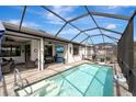 Enclosed pool area with lounge chairs and a covered patio at 1337 Sorrell Way, North Port, FL 34289