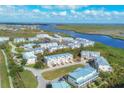 Scenic aerial shot of waterfront condos with beautiful river views and lush green surroundings at 10300 Coral Landings Ct # 93, Placida, FL 33946