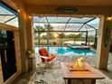 Relaxing pool area with fire pit and outdoor seating, plus a sauna at 13092 Rinella St, Venice, FL 34293