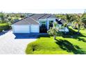 Beautiful home with tile roof, two-car garage, and lush landscaping at 15764 Autry Cir, Port Charlotte, FL 33981