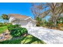 Two-story condo, two-car garage, and lush landscaping at 3113 Club Dr # 118, Port Charlotte, FL 33953