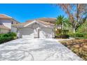 Two-car garage with driveway and manicured landscaping at 3113 Club Dr # 118, Port Charlotte, FL 33953