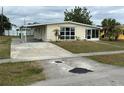 Ranch-style home with a carport and yard at 21242 Glendale Ave, Port Charlotte, FL 33952