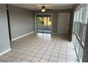 Bright living room featuring tile floors and sliding doors at 21242 Glendale Ave, Port Charlotte, FL 33952