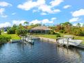 Waterfront home with private dock and boat lift, offering serene canal views at 15576 Aldama Cir, Port Charlotte, FL 33981