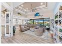 Spacious living area with large sectional sofa, high ceilings, and water views at 15576 Aldama Cir, Port Charlotte, FL 33981
