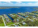 Aerial view showcasing home's waterfront location and neighborhood at 5105 Ackley Ter, Port Charlotte, FL 33981