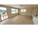 Bright living room with terrazzo floors and large windows at 1446 Fairless Rd, Englewood, FL 34223