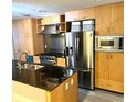 Modern kitchen with stainless steel appliances and granite countertops at 1120 E Kennedy Blvd # 1423, Tampa, FL 33602