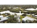 Aerial view showcasing home's canal-front location and neighborhood at 446 Court St, Englewood, FL 34223