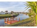 Scenic waterfront view with a dock and serene canal in a residential community at 6113 Partridge Ave, Englewood, FL 34224