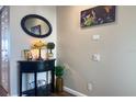 Nicely decorated hallway corner featuring a small black table, a decorative lamp, and an oval mirror at 2255 N Beach Rd # 9, Englewood, FL 34223