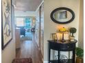 View of the hallway with wood floors that extends to the living area with sliding glass doors at 2255 N Beach Rd # 9, Englewood, FL 34223