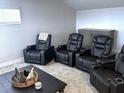 Home theater with four reclining chairs and a media cabinet at 16383 S Port Harbor Blvd, Port Charlotte, FL 33953