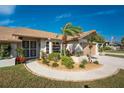 House exterior with lush landscaping and a paved walkway at 5826 Harrison Rd, Venice, FL 34293