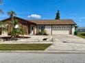 Ranch-style home with stone accents and a spacious driveway at 6358 Granger Rd, Port Charlotte, FL 33981