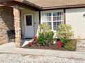 Landscaped entryway with stone pillars and a white front door at 6358 Granger Rd, Port Charlotte, FL 33981