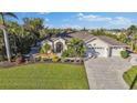 Two-story house with driveway and lush landscaping at 15375 Taurus Cir, Port Charlotte, FL 33981