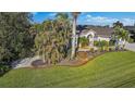 Landscaped yard with walkway leading to the house entrance at 15375 Taurus Cir, Port Charlotte, FL 33981