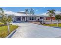 Front view of a single-story home with a metal roof and white picket fence at 2075 Pennsylvania Ave, Englewood, FL 34224