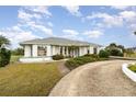 Single-story home with a landscaped yard and a gravel driveway at 4106 Library St, Port Charlotte, FL 33948