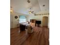 Bright living room with laminate flooring, comfy seating, and a ceiling fan at 7472 Stetson Ln, Port Charlotte, FL 33981