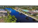 Aerial view of waterfront homes with boat docks and lush landscaping at 9567 Honeymoon Dr, Port Charlotte, FL 33981