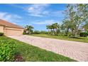 Brick-paved driveway leading to garage and home entrance at 13241 Creekside Ln, Port Charlotte, FL 33953