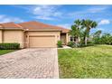 Tan single story home with tile roof and attached garage at 13241 Creekside Ln, Port Charlotte, FL 33953