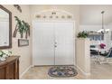 Bright entryway with double doors and view into the dining area at 171 Medalist Rd, Rotonda West, FL 33947