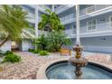 Tranquil courtyard featuring a water fountain and tropical landscaping at 2001 Bal Harbor Blvd # 2203, Punta Gorda, FL 33950