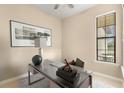 Bright home office features a glass desk and large window at 2759 Lavandula Ct, North Port, FL 34289