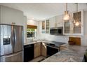 Modern kitchen with stainless steel appliances and marble countertops at 5850 Gasparilla Rd # M7, Boca Grande, FL 33921