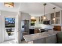 Modern kitchen with stainless steel appliances and marble countertops at 5850 Gasparilla Rd # M7, Boca Grande, FL 33921