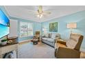 Relaxing living room featuring light blue walls and comfortable seating at 8527 Creekview Ln, Englewood, FL 34224