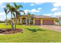 Single-story home with a two-car garage and palm trees at 912 Boundary Blvd, Rotonda West, FL 33947